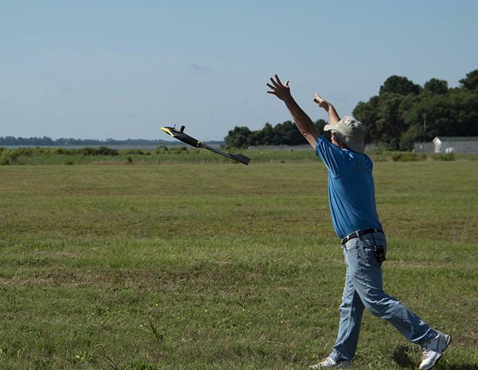 man launching drone